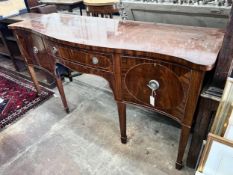 A George III style mahogany serpentine sideboard on square tapered legs, width 184cm, depth 63cm,