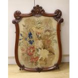 A Victorian petite point embroidered panel, in shield shaped mahogany frame (ex pole screen), 80cm