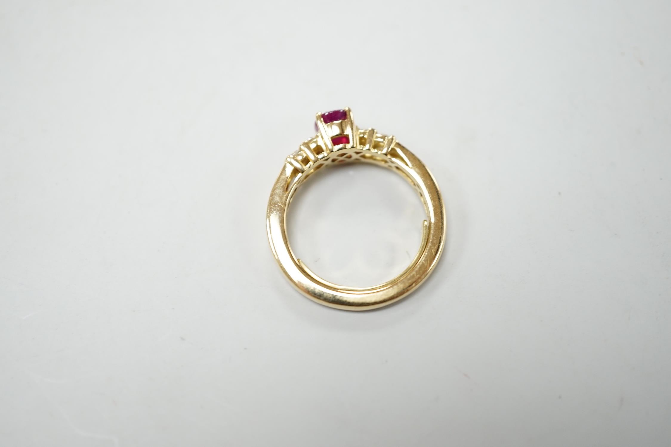A modern yellow metal and single stone oval cut ruby set dress ring, with ten stone diamond chip set - Image 3 of 3