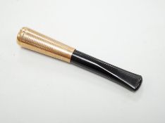 A 1960's 9ct gold mounted cigarette holder, 72mm, housed in Cartier box.