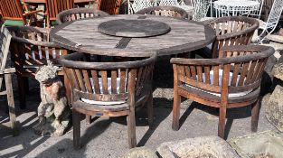 A large circular weathered teak garden table with Lazy Susan, diameter 180cm, height 75cm,
