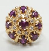 A modern 14ct gold, amethyst? and diamond chip cluster set domed dress ring, size M, gross weight