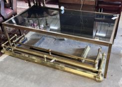 A mid century rectangular brass and smoked glass coffee table, length 135cm, depth 70cm, height