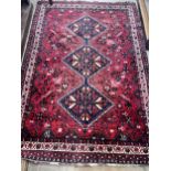 A Belouch red ground rug, 172 x 122cm