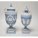 A Wedgwood blue jasper commemorative urn and cover and a similar smaller urn and cover, tallest