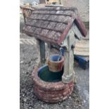A large reconstituted stone ornamental wishing well garden planter, height 97cm