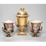A pair of Derby flower basket painted urns, c.1810, and a larger Derby urn and cover, first