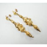 A pair of early 20th century yellow metal drop earrings, with scroll decoration, (later