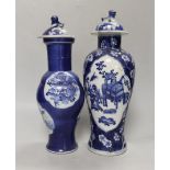 Two 19th century Chinese blue and white vases and covers, one with a dragon cartouche, the other a