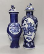 Two 19th century Chinese blue and white vases and covers, one with a dragon cartouche, the other a