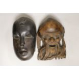 A Chinese Shou Lao wooden mask and an African mask, 26.5cm high