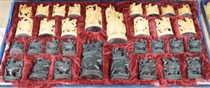 A cased Indian sandalwood and ebony figural chess set, case 50.5cm wide
