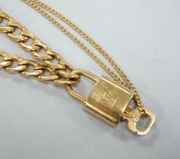 A Louis Vuitton gilt metal key and padlock pendant, 36mm, on a Boutique Secondlife of London, curb