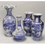 A pair of Japanese blue and white birds and flowers pattern vases and two other vases, tallest