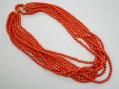 A 1980's Italian multi strand coral bead necklace, with 750 yellow metal clasp and Certificate of