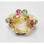 An 18ct and single stone yellow sapphire set dress ring, with emerald and ruby set setting and