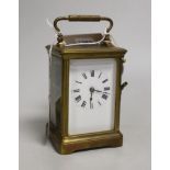 A brass carriage clock and a silver watch, clock 12cm high