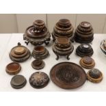 Twenty five assorted Chinese hardwood vase stands and two carved wooden vase covers, largest stand