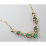 A modern 9ct gold, five stone marquise cut emerald and diamond chip cluster set necklace, 46cm,