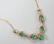 A modern 9ct gold, five stone marquise cut emerald and diamond chip cluster set necklace, 46cm,