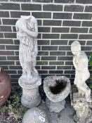A reconstituted stone garden ornament of a robed lady, head detached, and a stone birdbath,