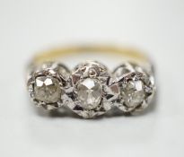 A yellow metal and illusion set three stone diamond ring, size M, gross weight 4.1 grams.