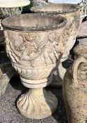 A pair of large circular reconstituted stone garden planters, moulded with a band of putti on square