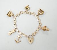 A 1950's 9ct gold charm bracelet hung with six assorted charms, gross weight 25.5 grams.