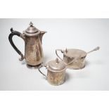 An early 20th century silver hot water pot and two silver mustard pots.