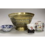 An early 20th century Chinese famille rose tea bowl and stand together with a brass ‘dragon’ bowl, a