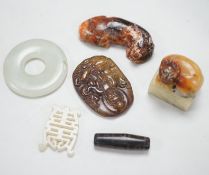A Chinese pale celadon jade bi disc, a jade carving of the character ‘Shou’ , two hardstone carvings