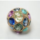 A Middle Eastern yellow metal and multi gem set domed dress ring, size K/L, gross weight 10.5
