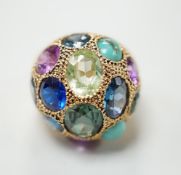A Middle Eastern yellow metal and multi gem set domed dress ring, size K/L, gross weight 10.5