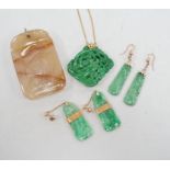 A Chinese carved hardstone pendant, 64mm, a pierced green hardstone pendant on chain and two pairs