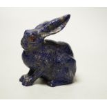 A Chinese lapis lazuli model of a hare, with glass inset eyes, 8.4cm high