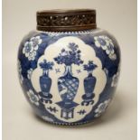 A 19th century Chinese blue and white prunus jar and carved wood cover, 24cm