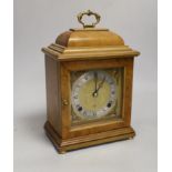 A figured walnut mantel clock by Elliott