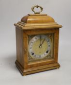 A figured walnut mantel clock by Elliott