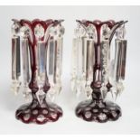 A pair of Victorian ruby overlaid glass table lustres, 28cm