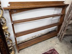 An Arts and Crafts oak three tier plate rack, width 140cm, height 97cm