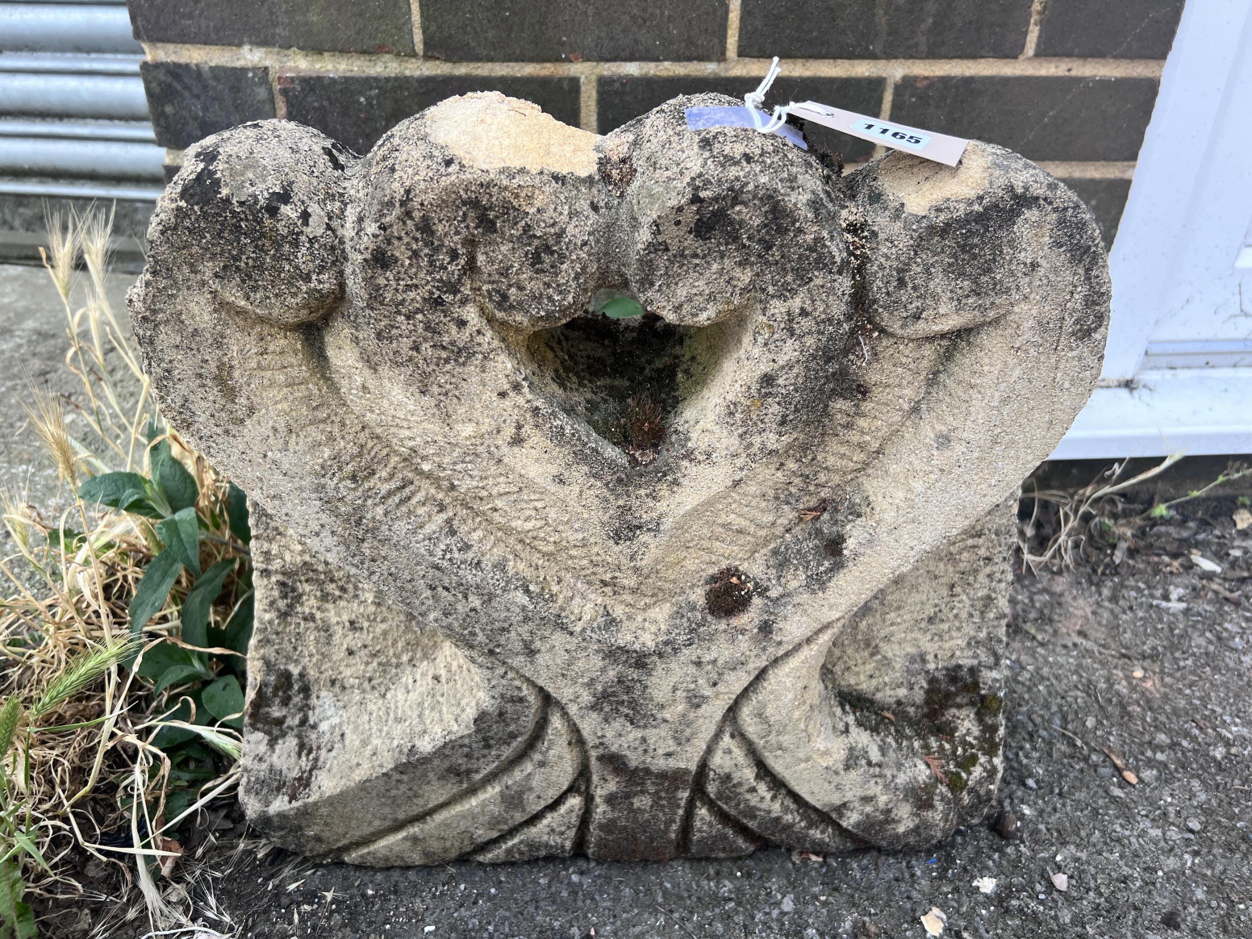 A Portland stone carved corbel, width 50cm, height 47cm