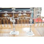 A large pair of plated two branch, three light candelabra, 58cm high, 37cm wide