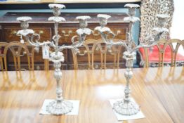 A large pair of plated two branch, three light candelabra, 58cm high, 37cm wide