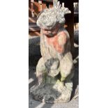 A reconstituted stone garden fountain modelled as a figure of a cherub holding a dolphin, height