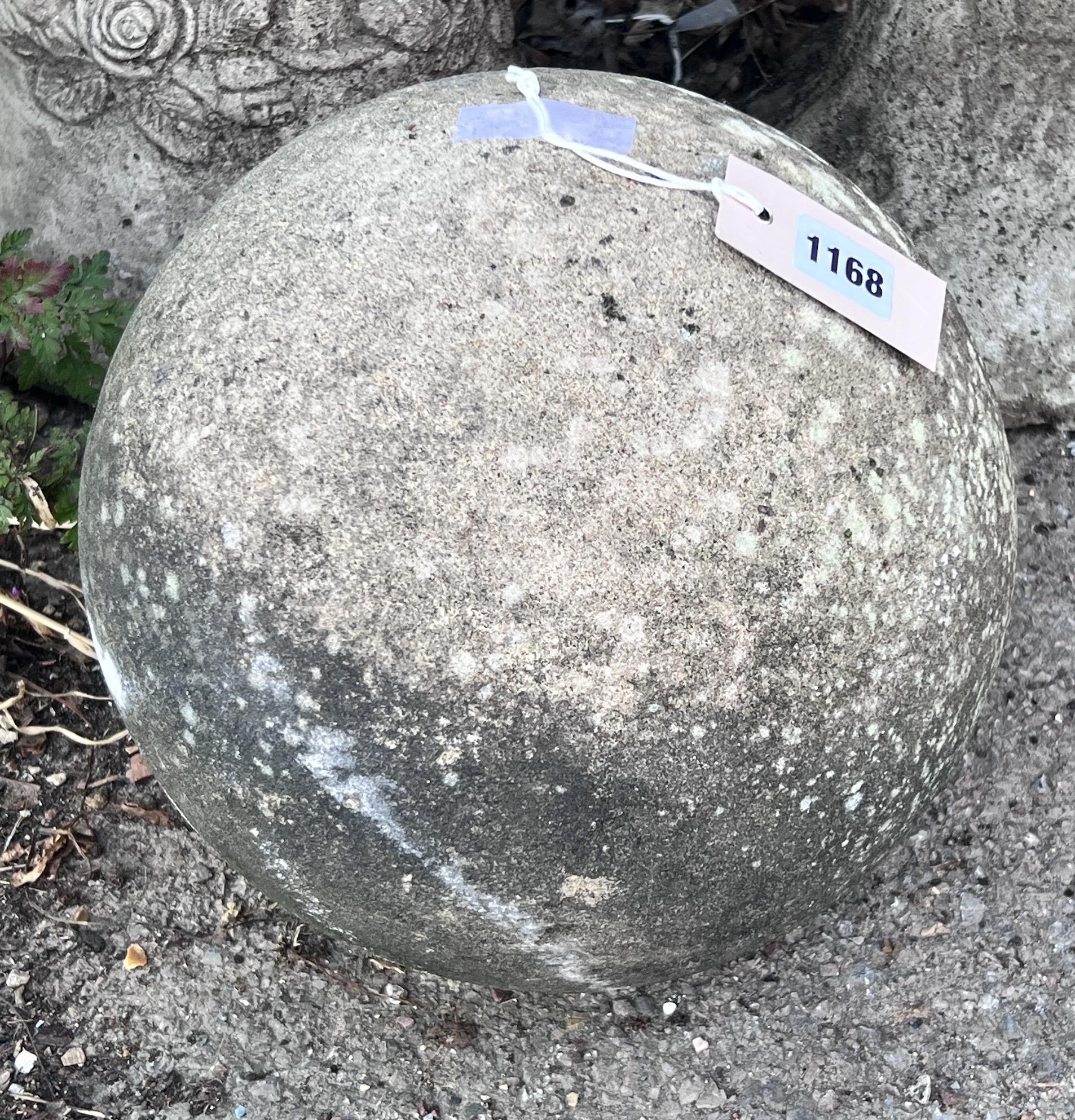 A stone cannon ball garden ornament, height 24cm