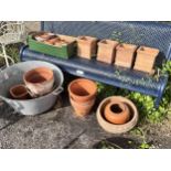 A large circular galvanised tub, diameter 72cm, together with a quantity of assorted terracotta