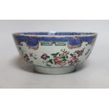 A Chinese famille rose bowl, Qianlong period, painted with insects amongst flowers, 23cm in