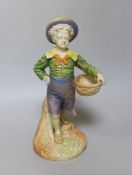 A Royal Worcester figure of a boy with a basket and a broad brimmed hat painted in shot enamels