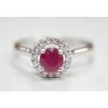 A modern 18ct white gold, ruby and diamond set circular cluster ring, size M, gross weight 3.1