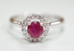 A modern 18ct white gold, ruby and diamond set circular cluster ring, size M, gross weight 3.1